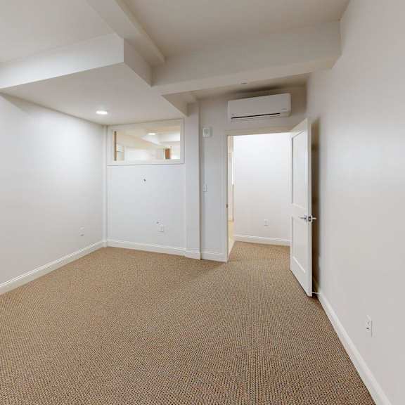 a room with carpeted floor and white walls.