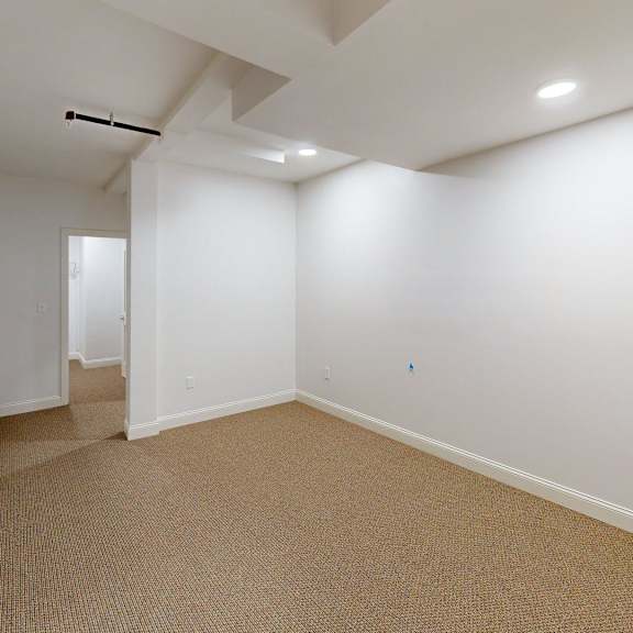 a room with carpeted floor and white walls.