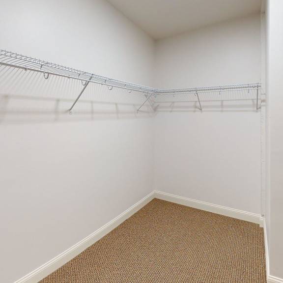 a white wall with a metal rack on it.