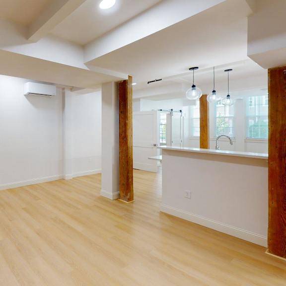 a room with wooden floors and white walls.