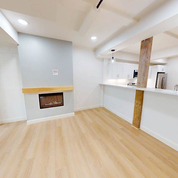 a room with a fireplace and wooden floors.