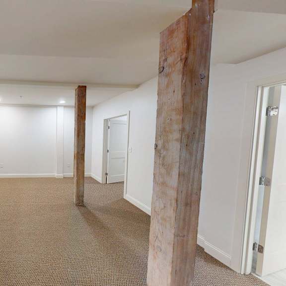 a room with a carpeted floor and white walls.