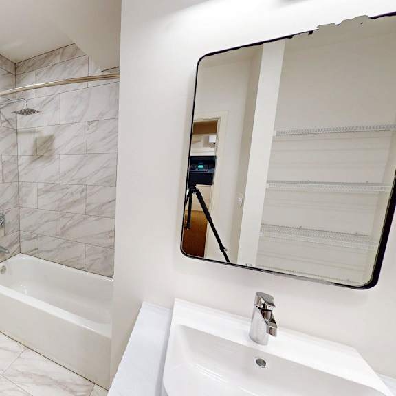 a white toilet sits next to a white sink in a bathroom.