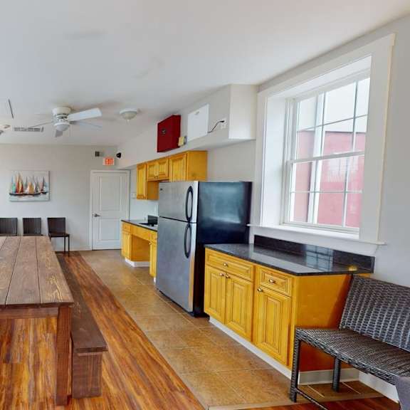 a kitchen with a wooden table and benches.