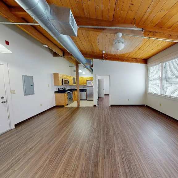 a room with wooden floors and a white door.