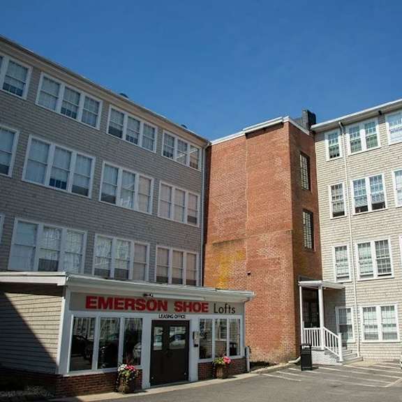 a brick building with a sign that says emerson shoe lofts.
