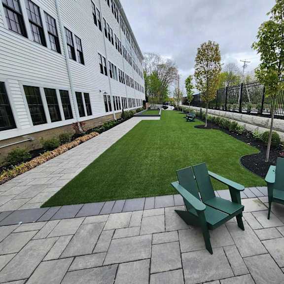 a patio with a bench and a fence.