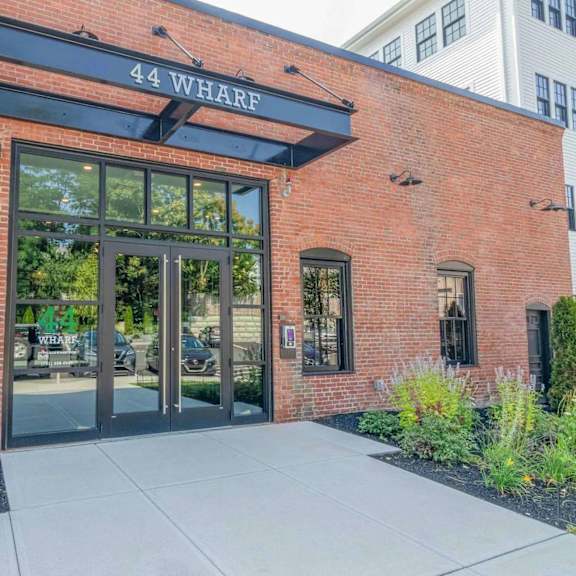 the entrance to a building with a sign that reads "44 wharf".