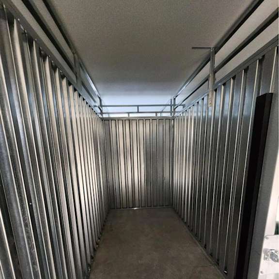 a room under construction with metal studs on the walls.
