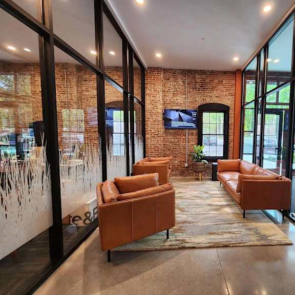 a modern living room with a brick wall and a flat screen tv.