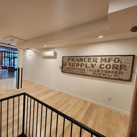 a sign on the wall that says "francer mfg. & supply core & customer pickup".