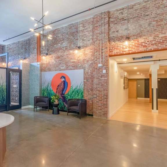 a room with a large mural and a round table in the center.