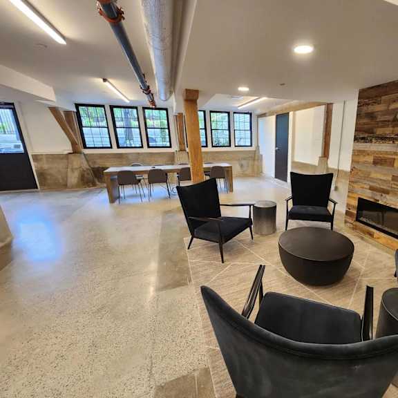 a room with black chairs and a wooden wall.