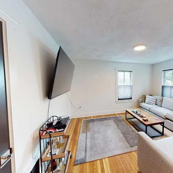a living room with a grey couch and a wooden coffee table.