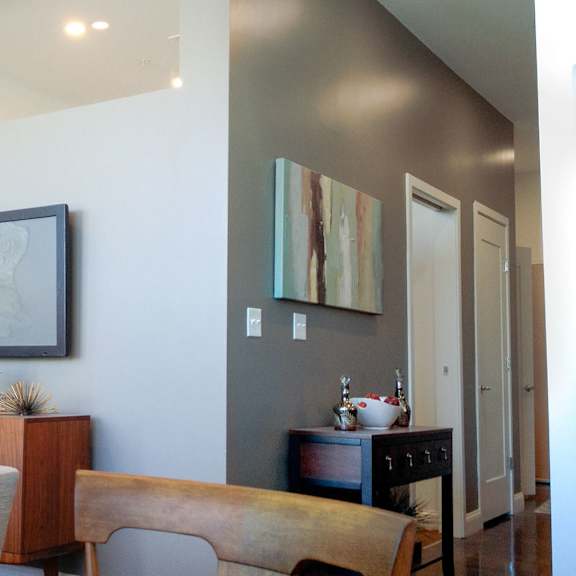 a living room with a grey couch and a wooden table.