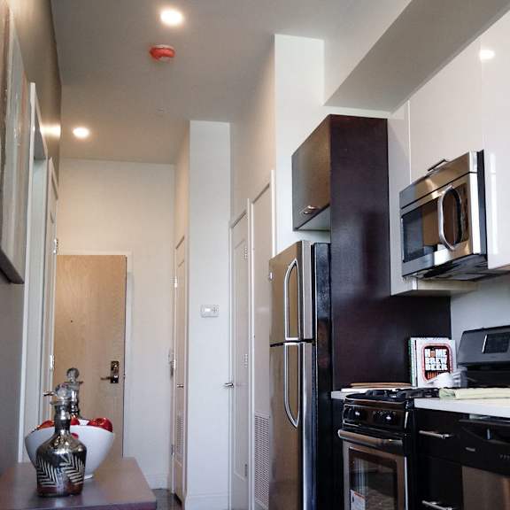 a kitchen with black appliances and white cabinets.