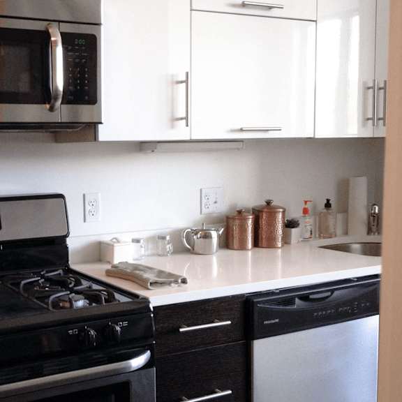 a black stove top oven with a digital display in the middle.