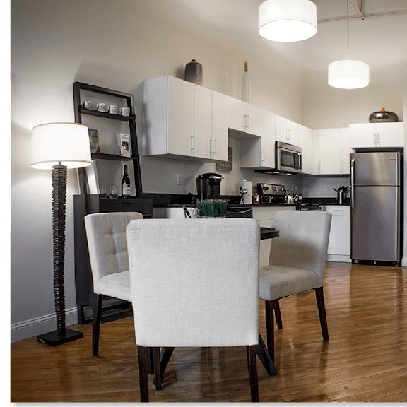 a kitchen with a dining table and chairs.