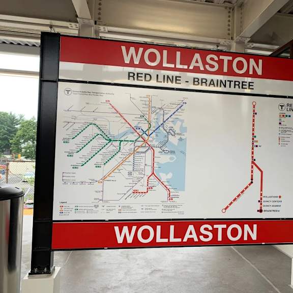 a sign for the red line at wollaston station.