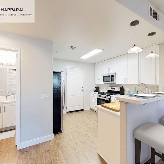 a well-lit kitchen with a dining table and chairs at mission hills, camarillo, 93012