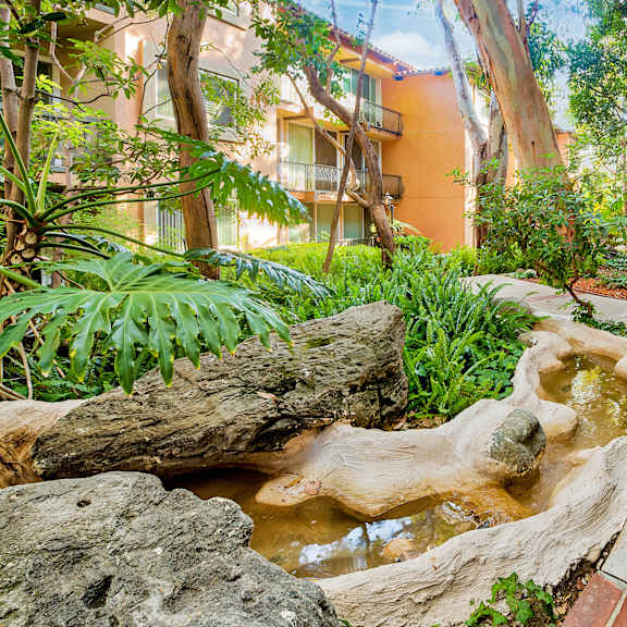 a small waterfall in the middle of a courtyard  at casa granada, los angeles, ca