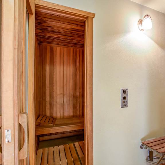 a sauna room with a shower and a wooden bench at valley plaza villages, california, 94566