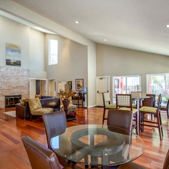 a living room with a glass table and a fireplace at valley plaza villages, pleasanton, california