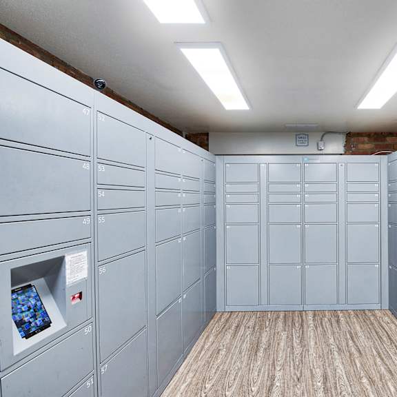 a bunch of white lockers in a room with a wood floor at the meadows apartments, culver city , ca 90230
