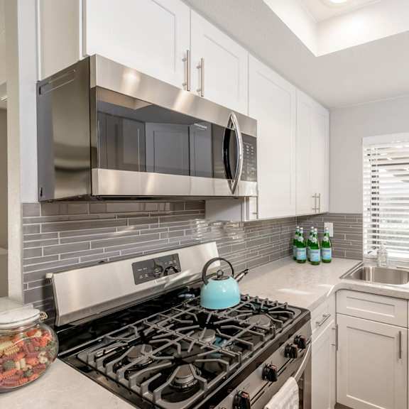a kitchen with a gourmet stove and a sink at sendero huntington beach, huntington beach california