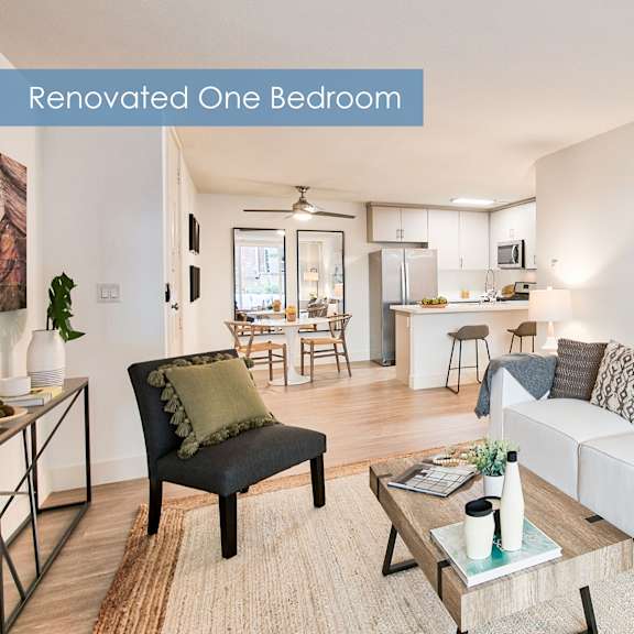 a living room with a surfboard painting on the wall at the meadows apartments, culver city , ca 90230