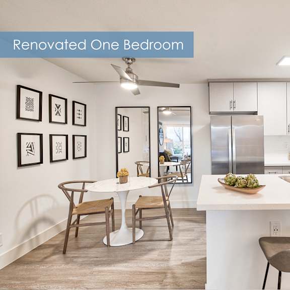 a renovated one bedroom apartment with a kitchen and dining area at the meadows apartments, culver city , ca 90230