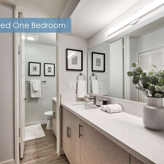a renovated one bedroom bathroom with a towel hanging on the door at the meadows apartments, culver city , ca 90230