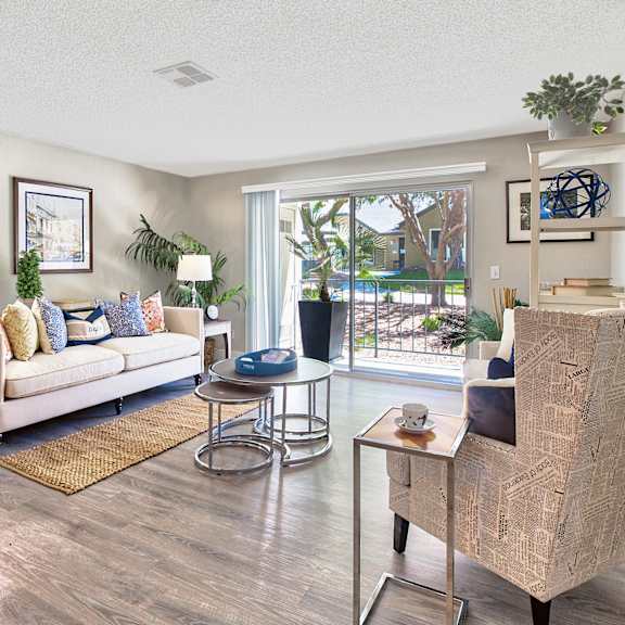 a living room with a white sofa and a wooden coffee table at mountain vista, victorville, ca