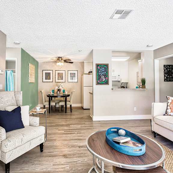 a living room with a white couch, a coffee table, and a dining table at mountain vista, victorville, ca