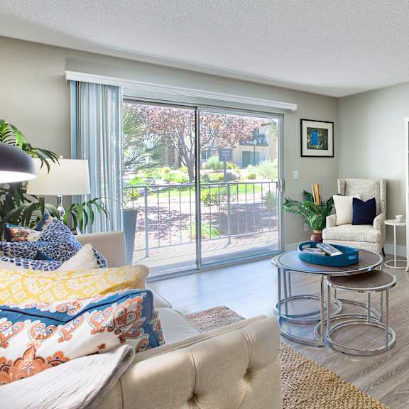 a living room with a sofa, chair, and a table with a plant on it at mountain vista, victorville, ca
