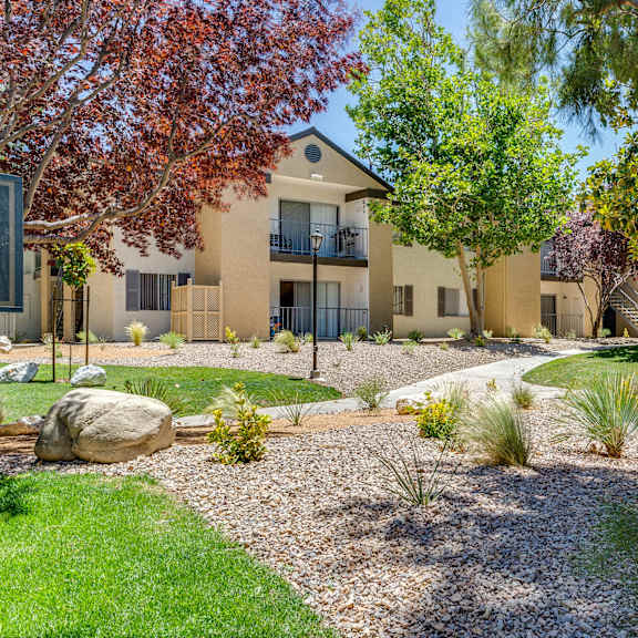 a modern house with a well-maintained garden in front at mountain vista, victorville, ca