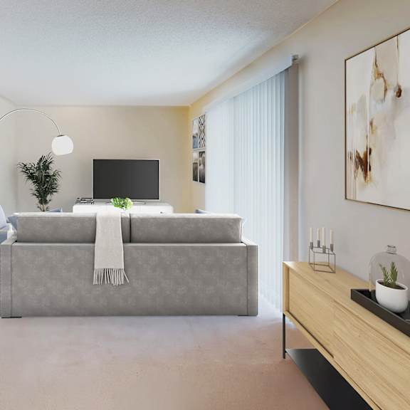 a modern living room with a grey sofa and a television at pleasanton glen apartments, pleasanton, california