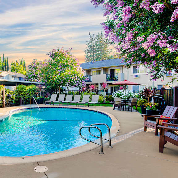 a pool surrounded by chairs and trees at pleasanton place, pleasanton, ca, 94566