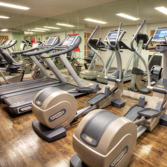 a gym with treadmills and elliptical machines at sunset barrington gardens, los angeles, 90049