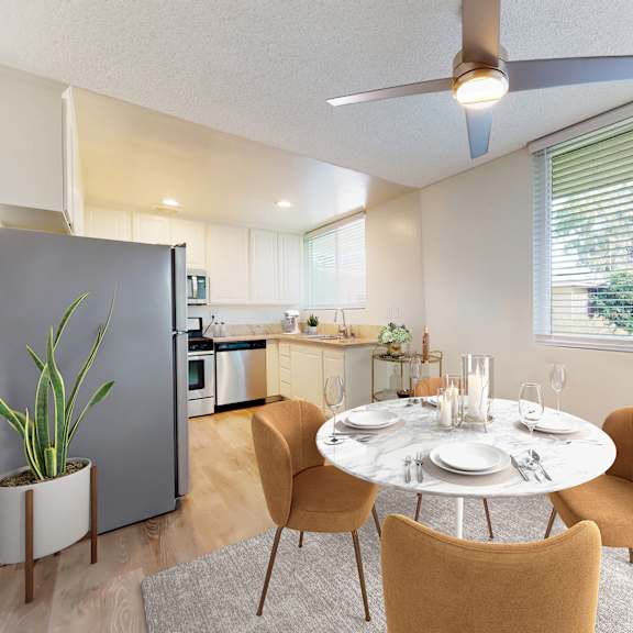 a dining room with a table set for two and a ceiling fan at sunset barrington gardens, los angeles, 90049