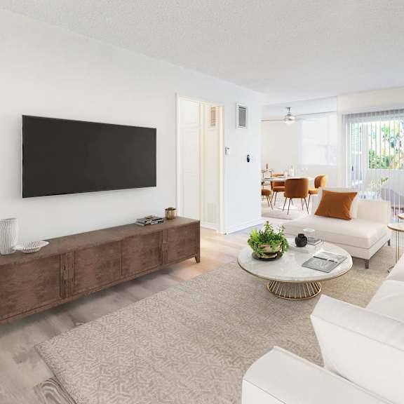 a living room with a white couch, a coffee table, and a flat screen tv at sunset barrington gardens, los angeles, 90049