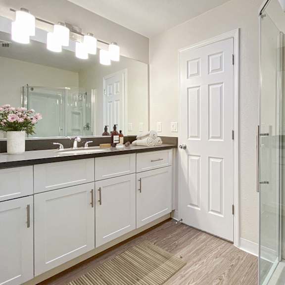 a bathroom with a white door and a glass shower at valley plaza villages, california, 94566
