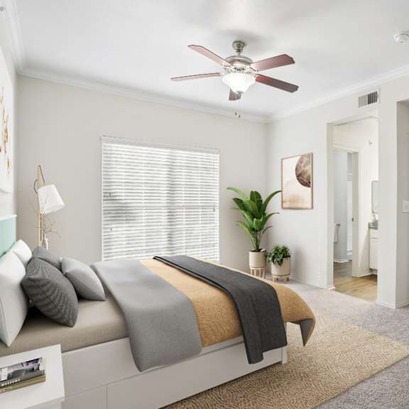 Thumbnail 8 of 16 A bedroom with a bed, a ceiling fan, and a rug.