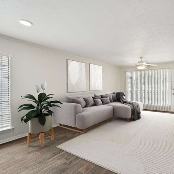 a living room with a gray couch and a white rug at woodlands of plano apartments in plano, tx