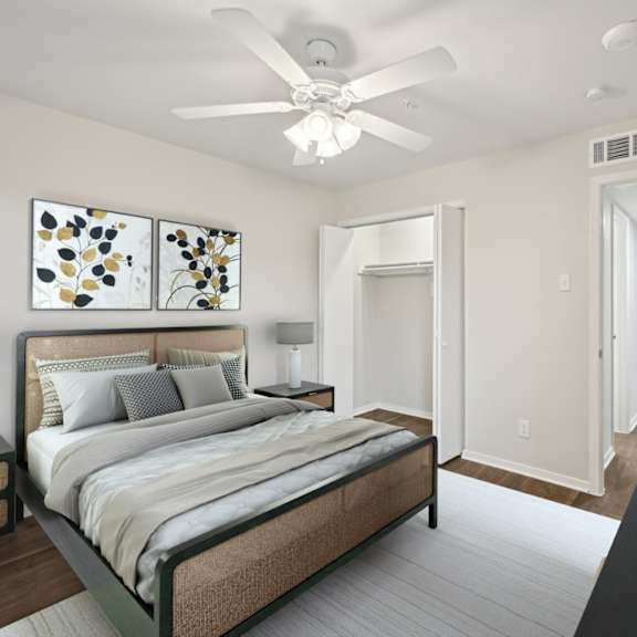 a bedroom with a large bed and a ceiling fan at woodlands of plano in plano, tx