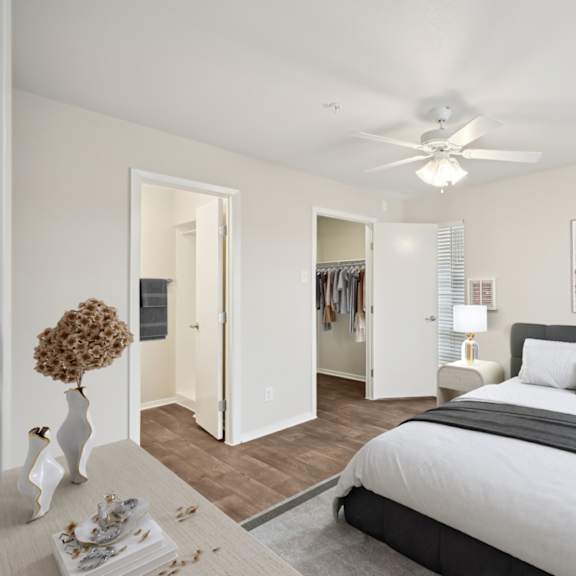 a bedroom with a large bed and a ceiling fan