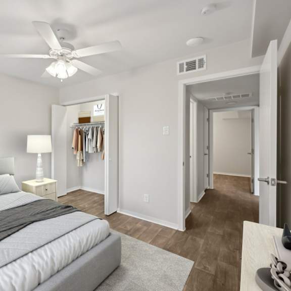 a bedroom with a large bed and a ceiling fan