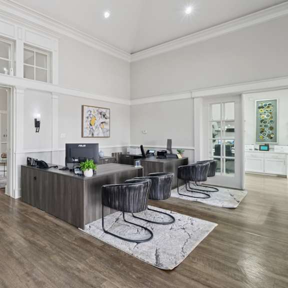 leasing office with desks and a lounge area at jefferson place apartments in irving, tx