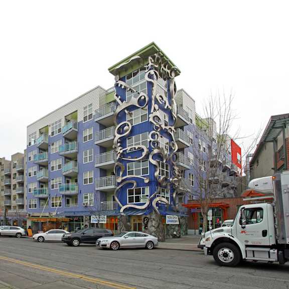 A large blue and white building with a face on it.