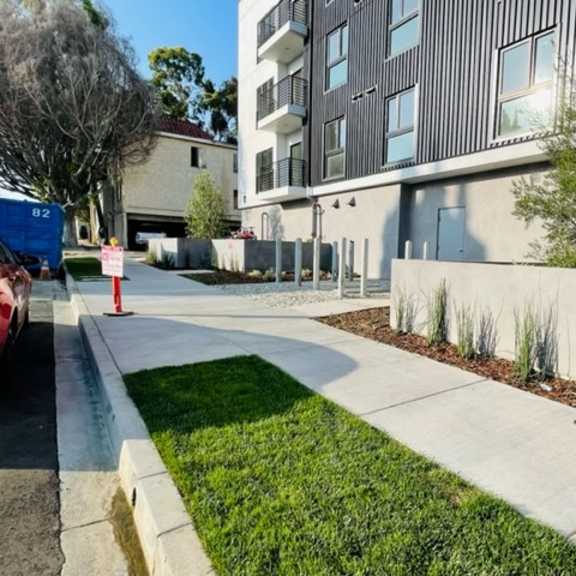 modern apartment building exterior with landscaped courtyard at lido - 1532 brockton ave apartments, california